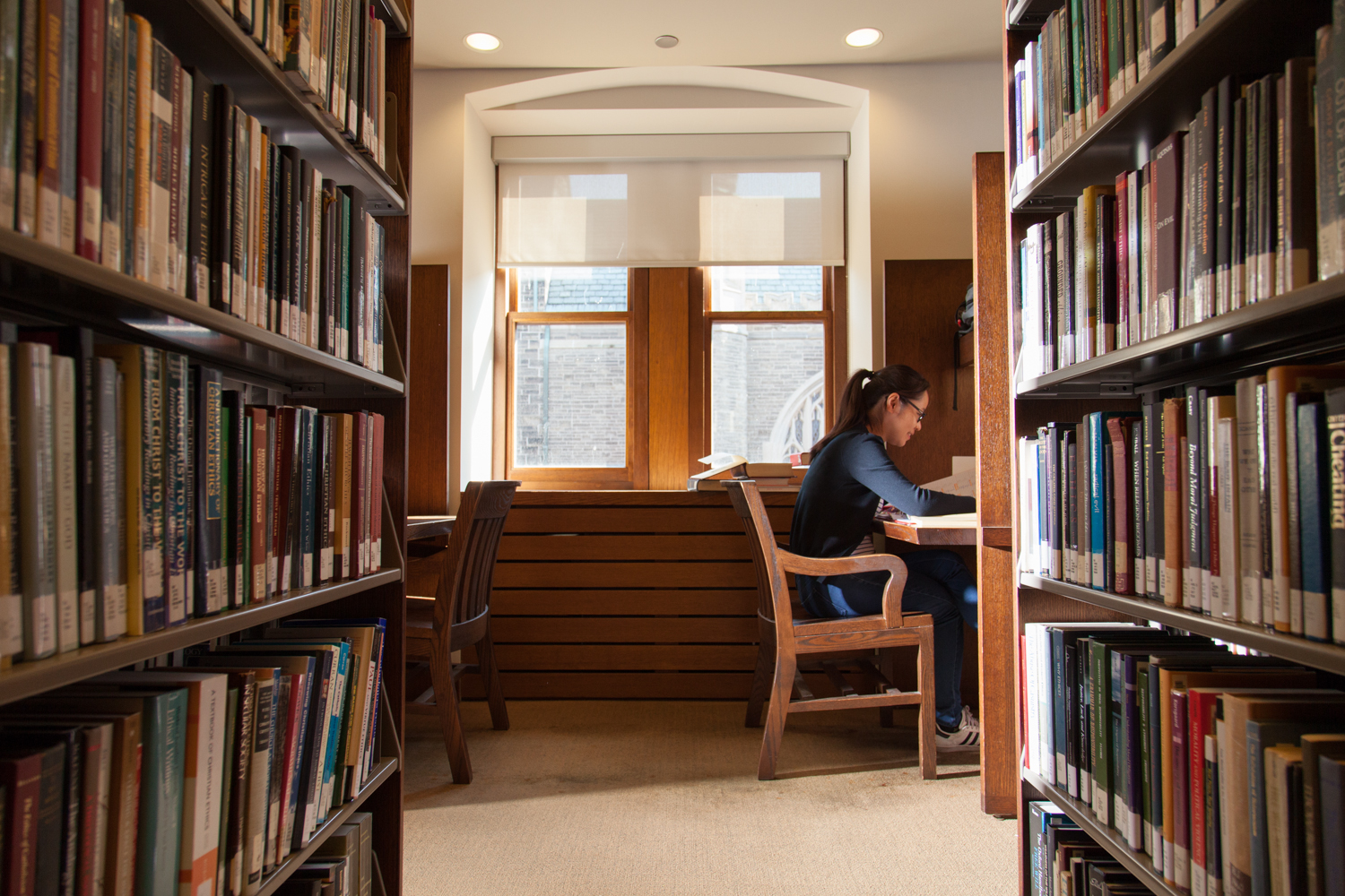Student studying in a carrel in the John W. Graham Library